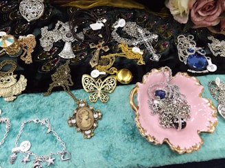 a table topped with lots of different types of jewelry