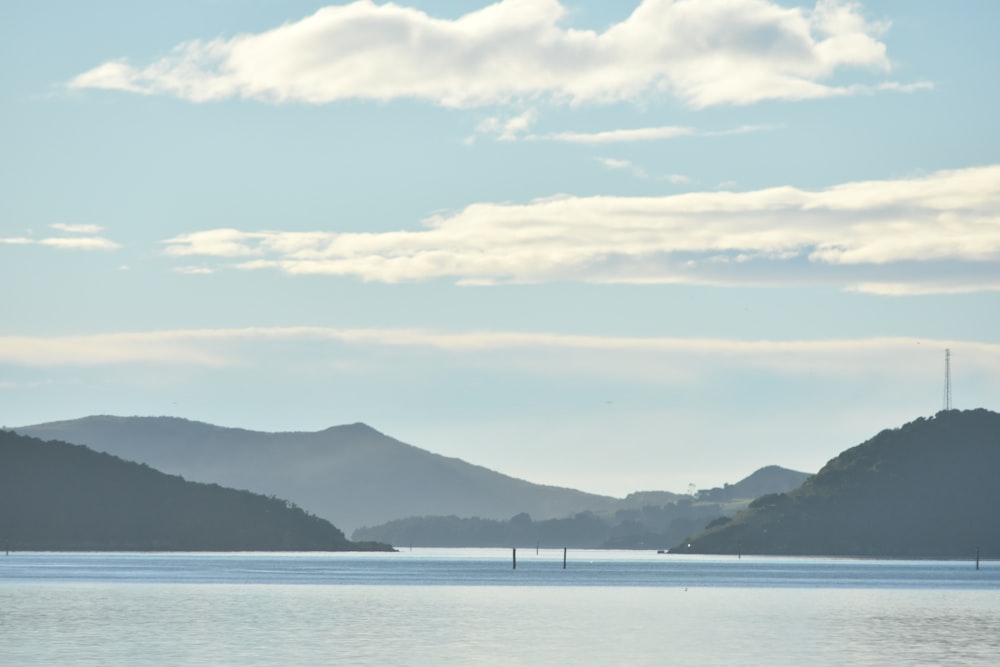 a large body of water with mountains in the background