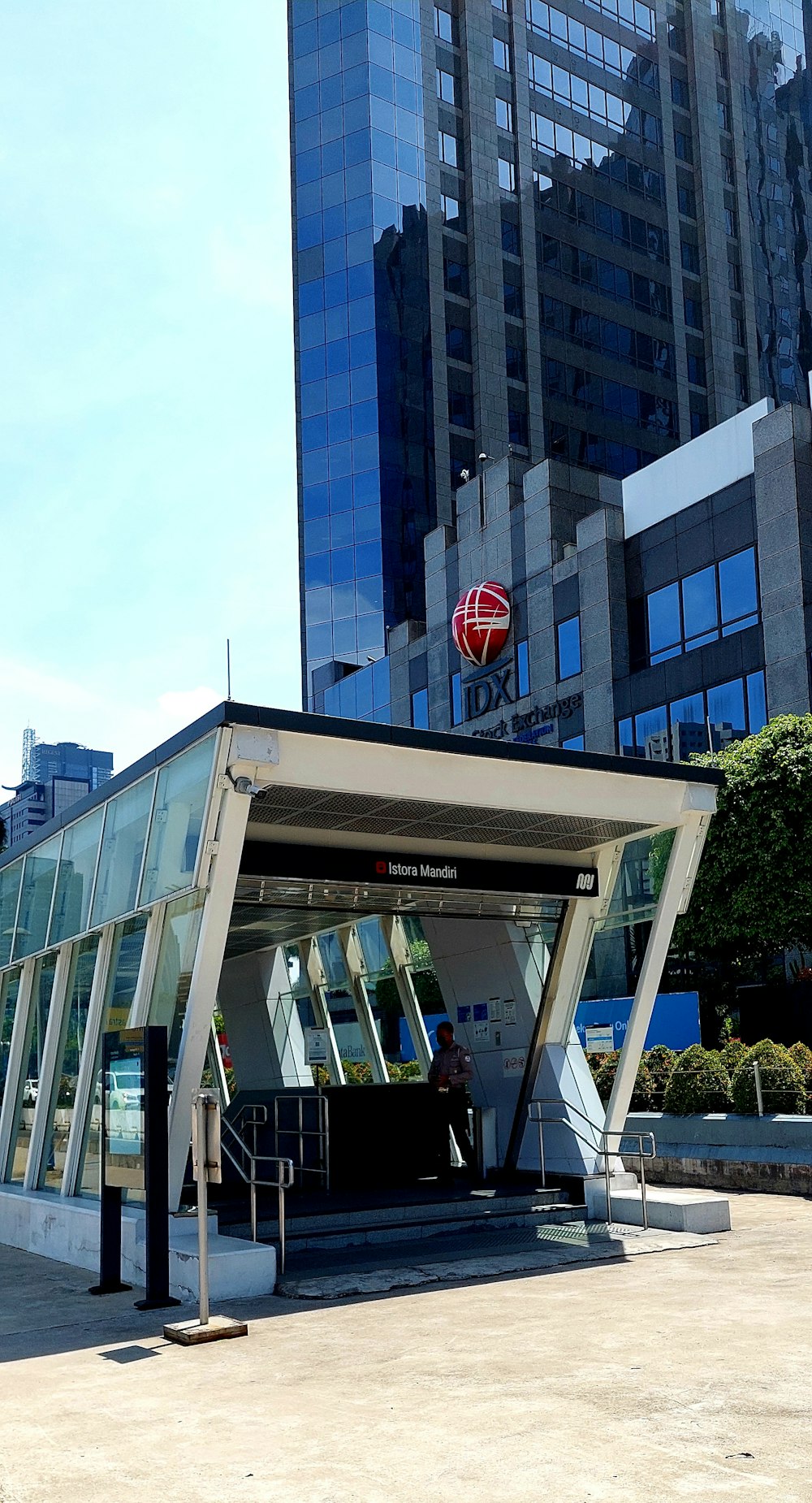 a bus stop in front of a very tall building