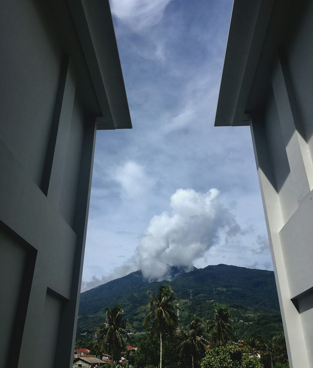 a view of a mountain through two windows