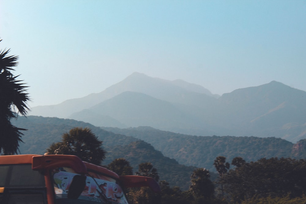 a bench with a view of mountains in the distance