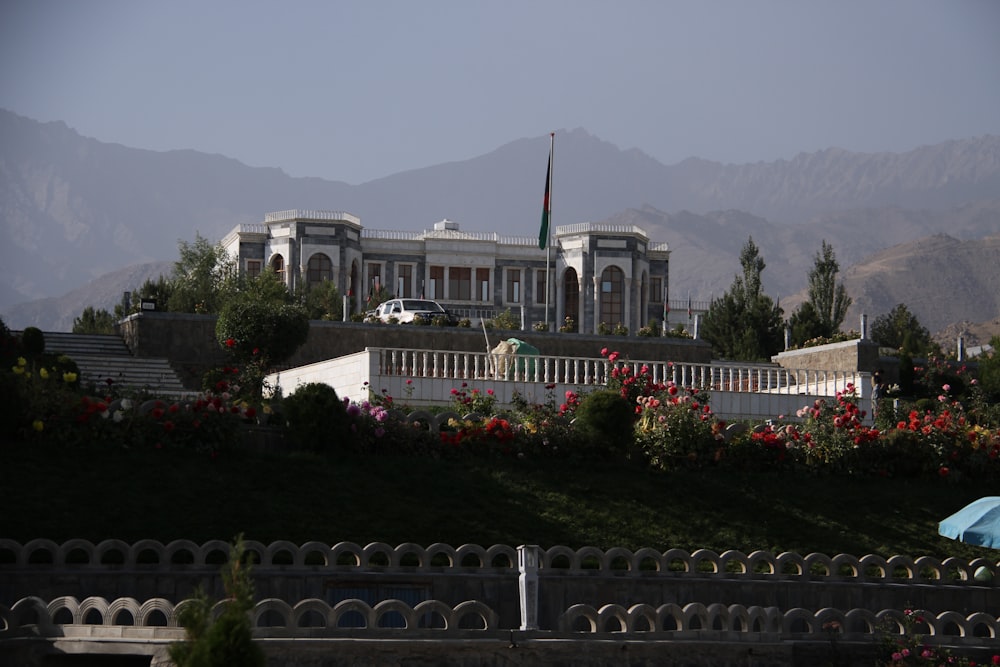 a large white building with a fence around it