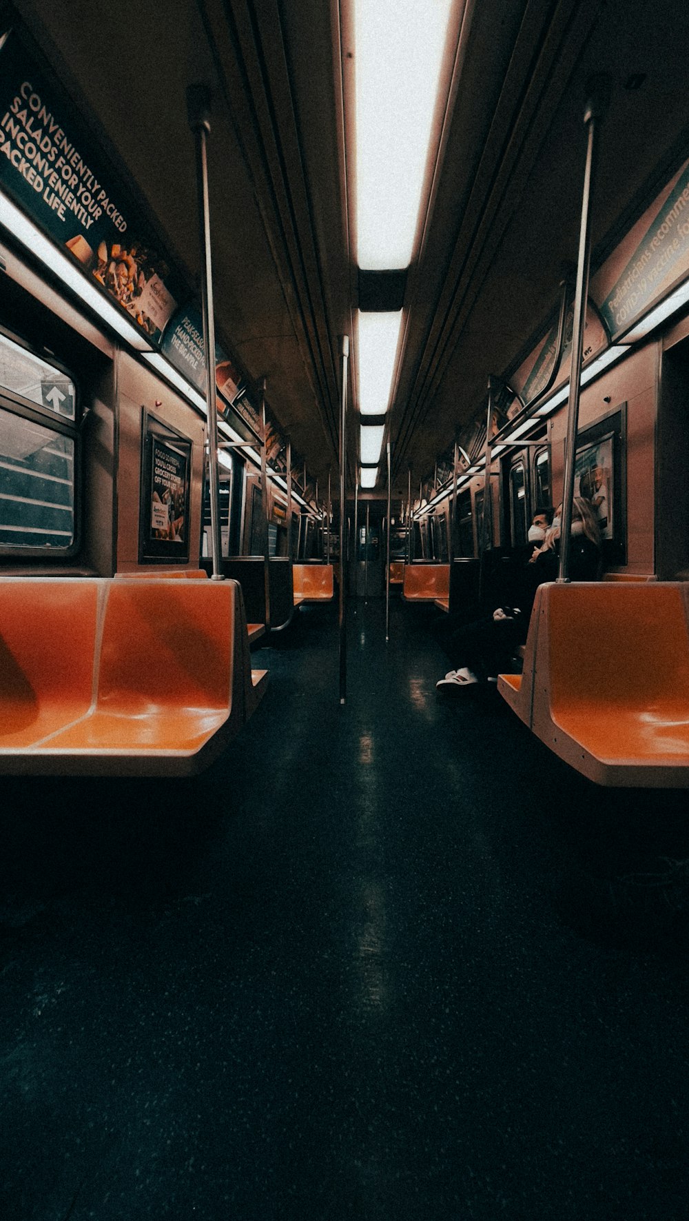 an empty subway car with orange seats