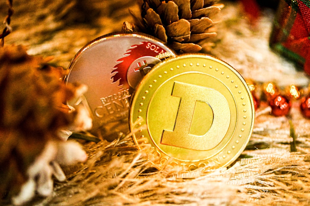 a gold coin sitting on top of a pile of christmas decorations