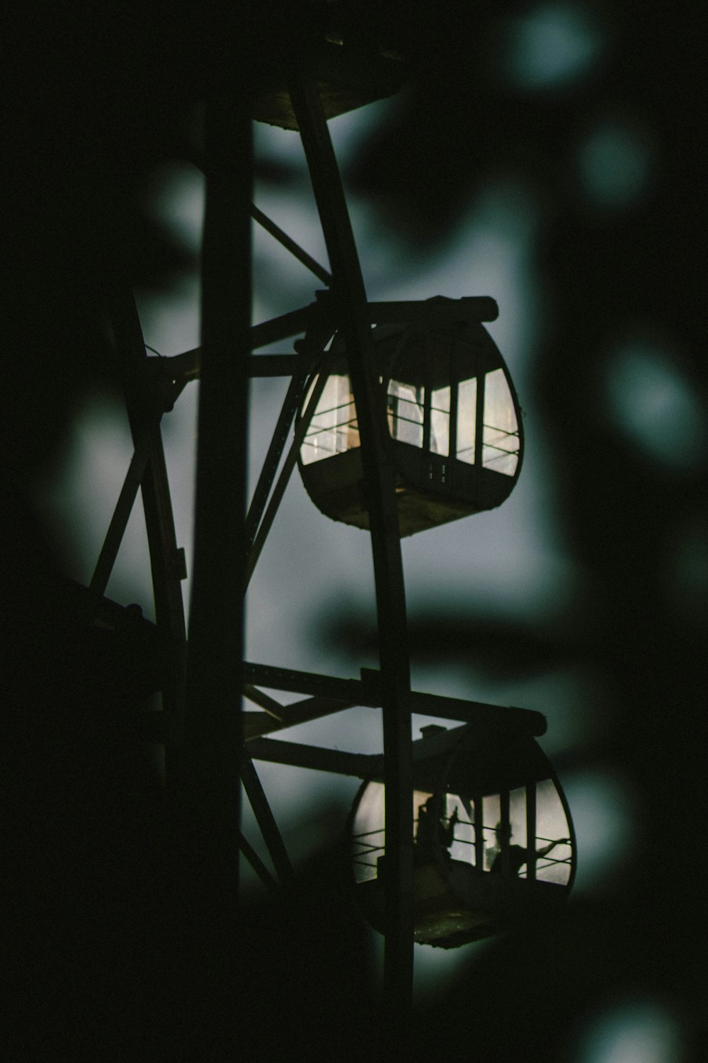 a ferris wheel in the dark with its lights on