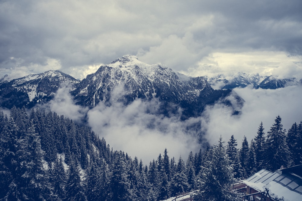 a view of a snowy mountain with a house in the foreground