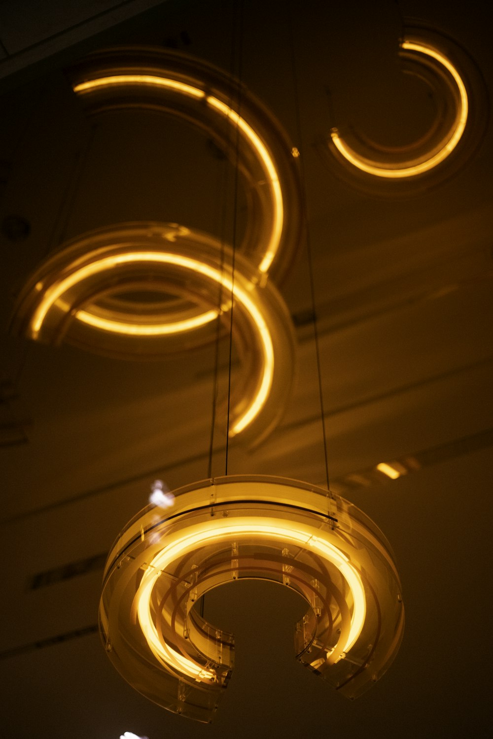 a group of circular lights hanging from a ceiling