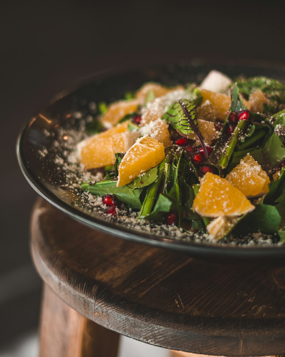 a plate of food with oranges and greens