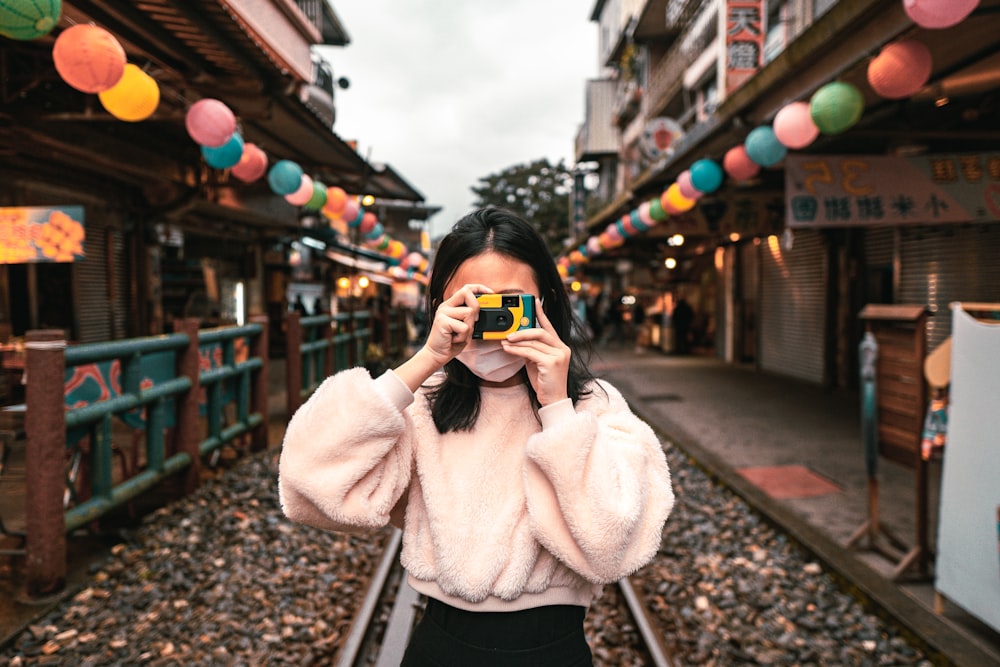 a woman taking a picture of herself with a camera