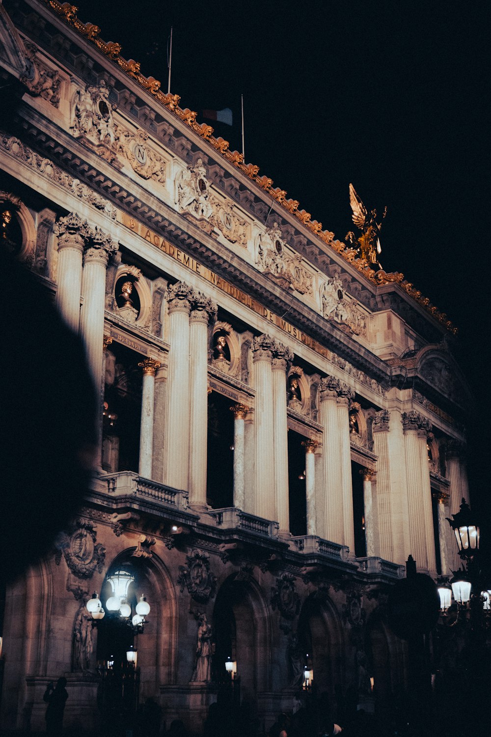 a large building with a statue on top of it