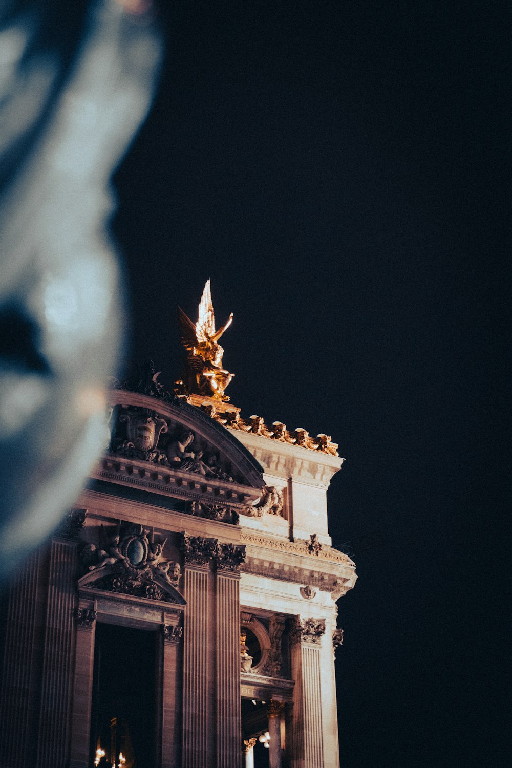 a clock tower with a statue on top of it