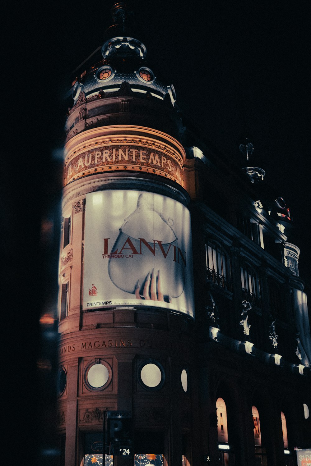 a large building with a lit up sign on it's side