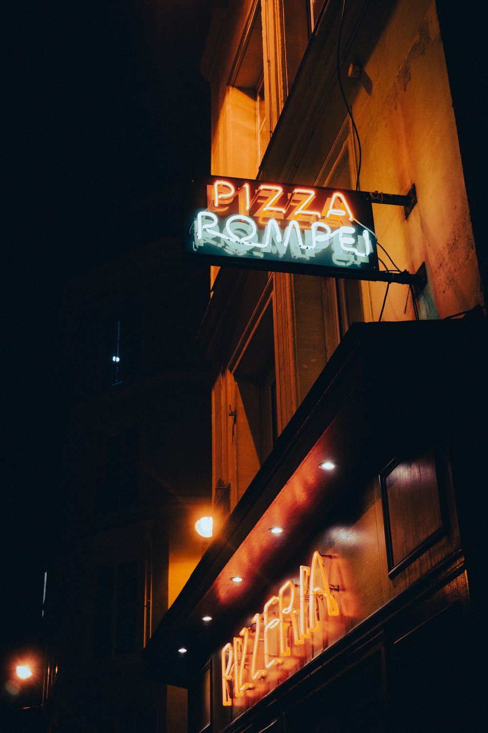 a neon sign on the side of a building