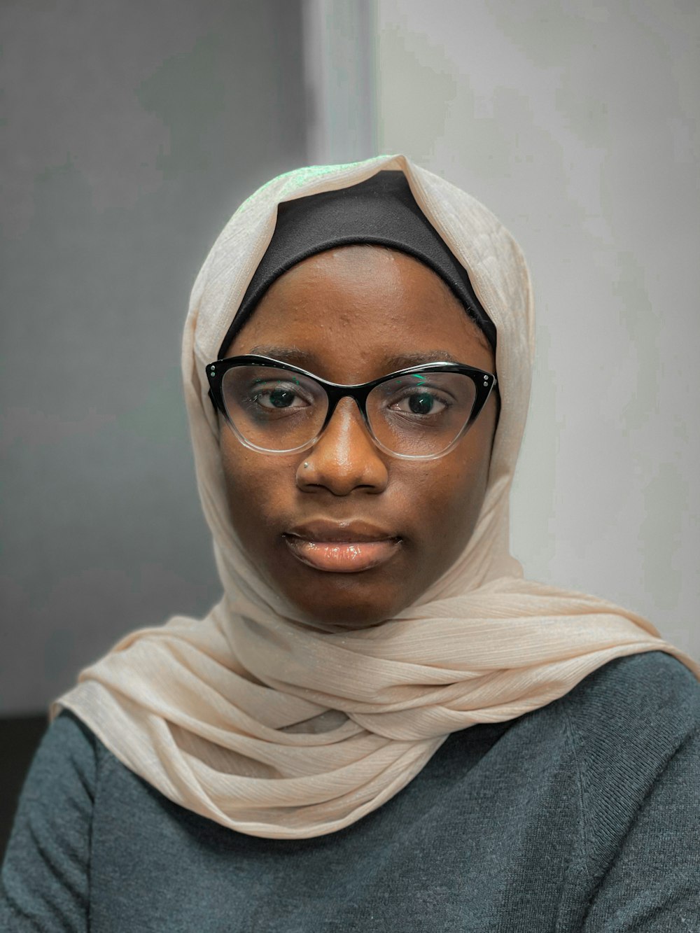 a woman wearing glasses and a headscarf