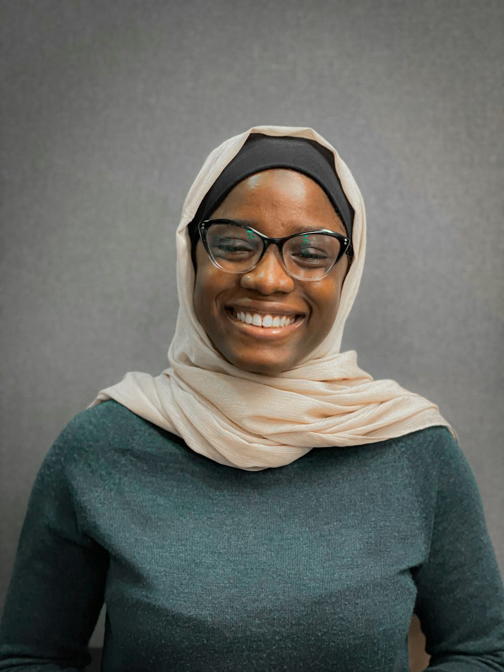 a woman wearing glasses and a headscarf