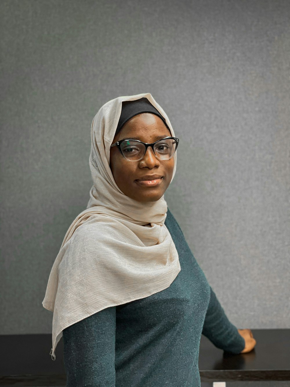 a woman wearing glasses and a headscarf