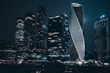 Sleek international city skyline with illuminated skyscrapers at night.