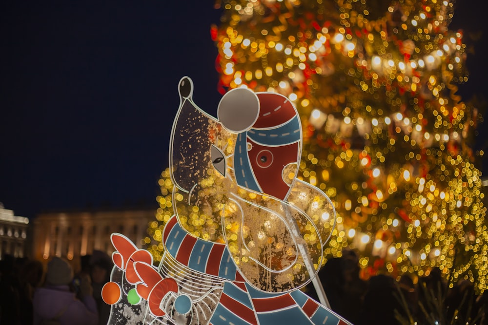 a large christmas tree with lights in the background