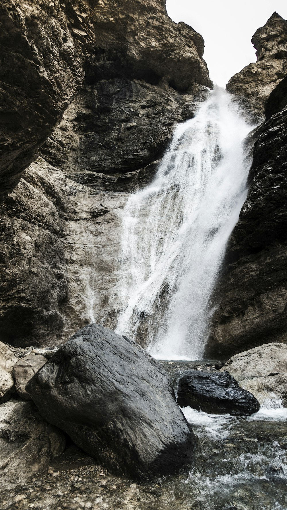 a waterfall is coming out of the rocks