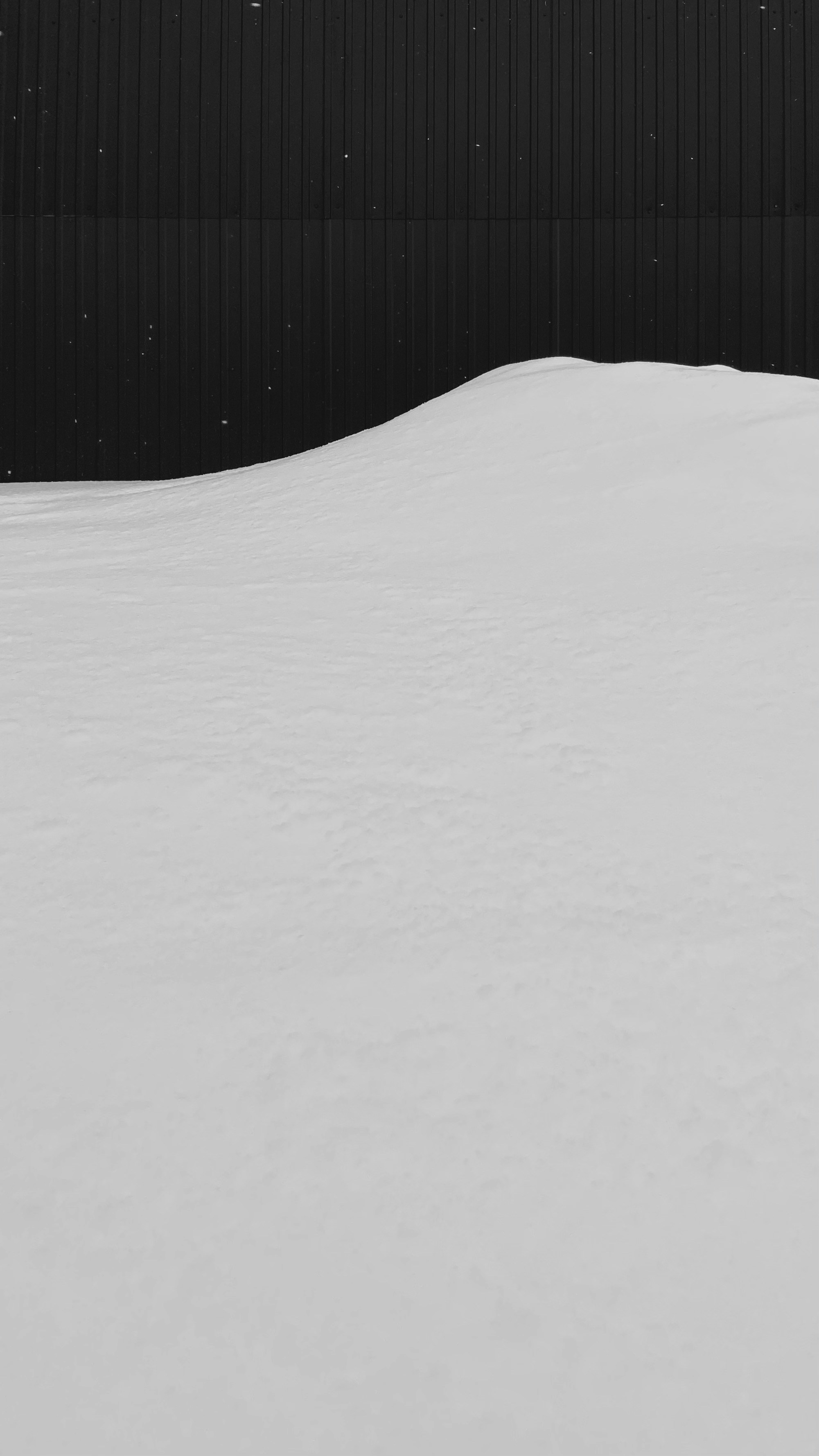 a man riding a snowboard down a snow covered slope