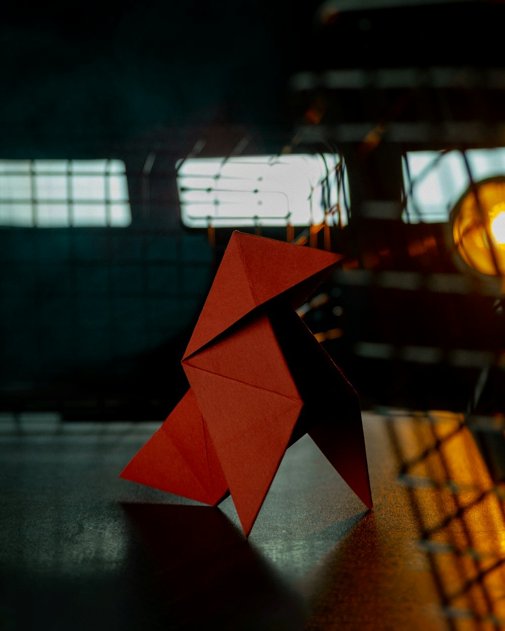 a red origami object sitting on top of a table