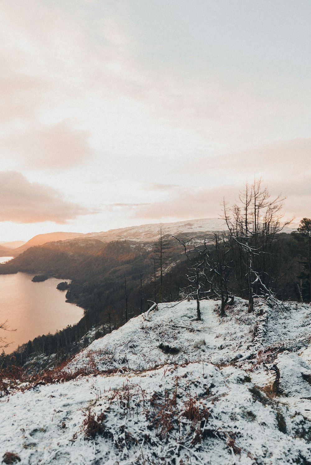 a person standing on top of a snow covered hill