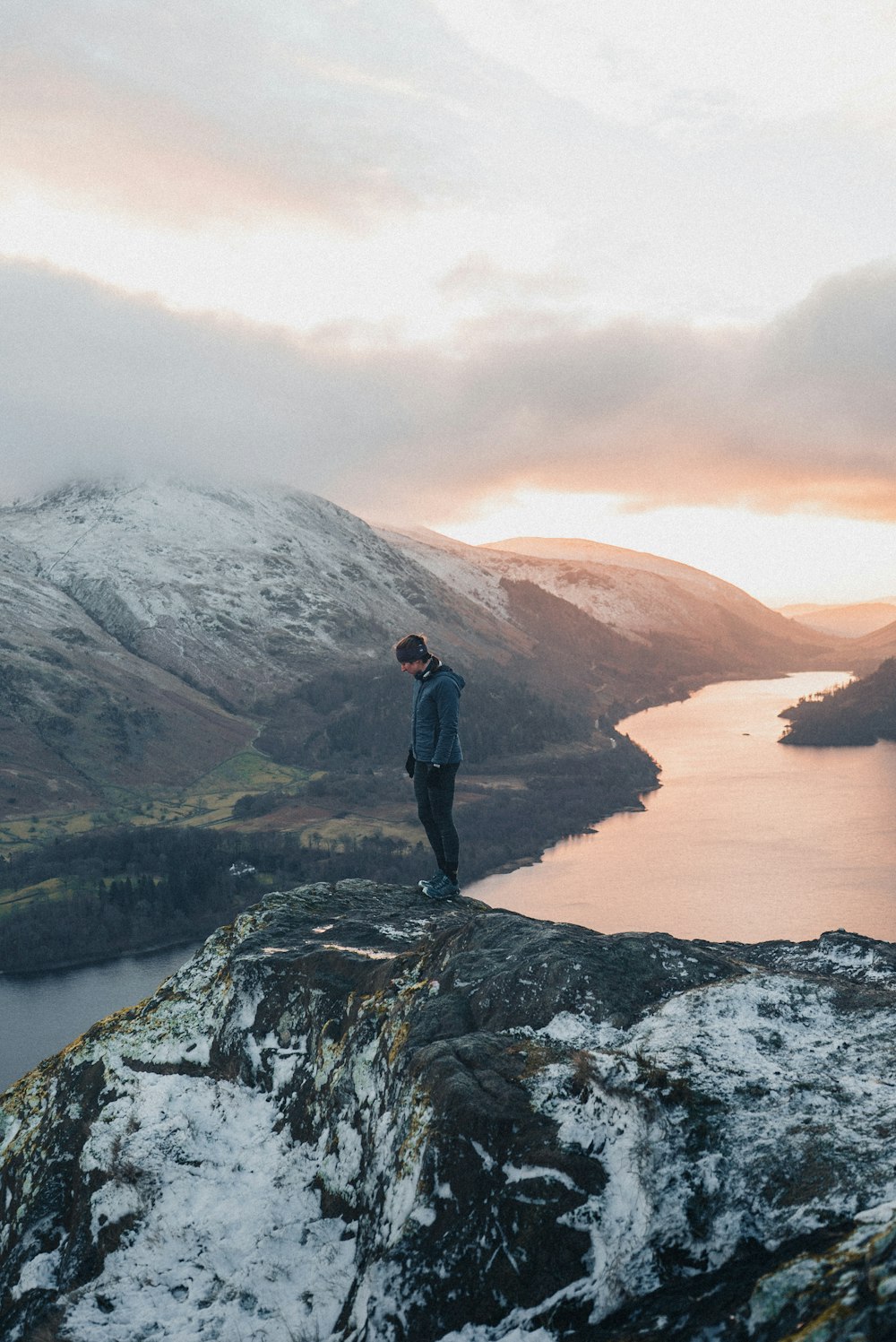 a man standing on top of a snow covered mountain