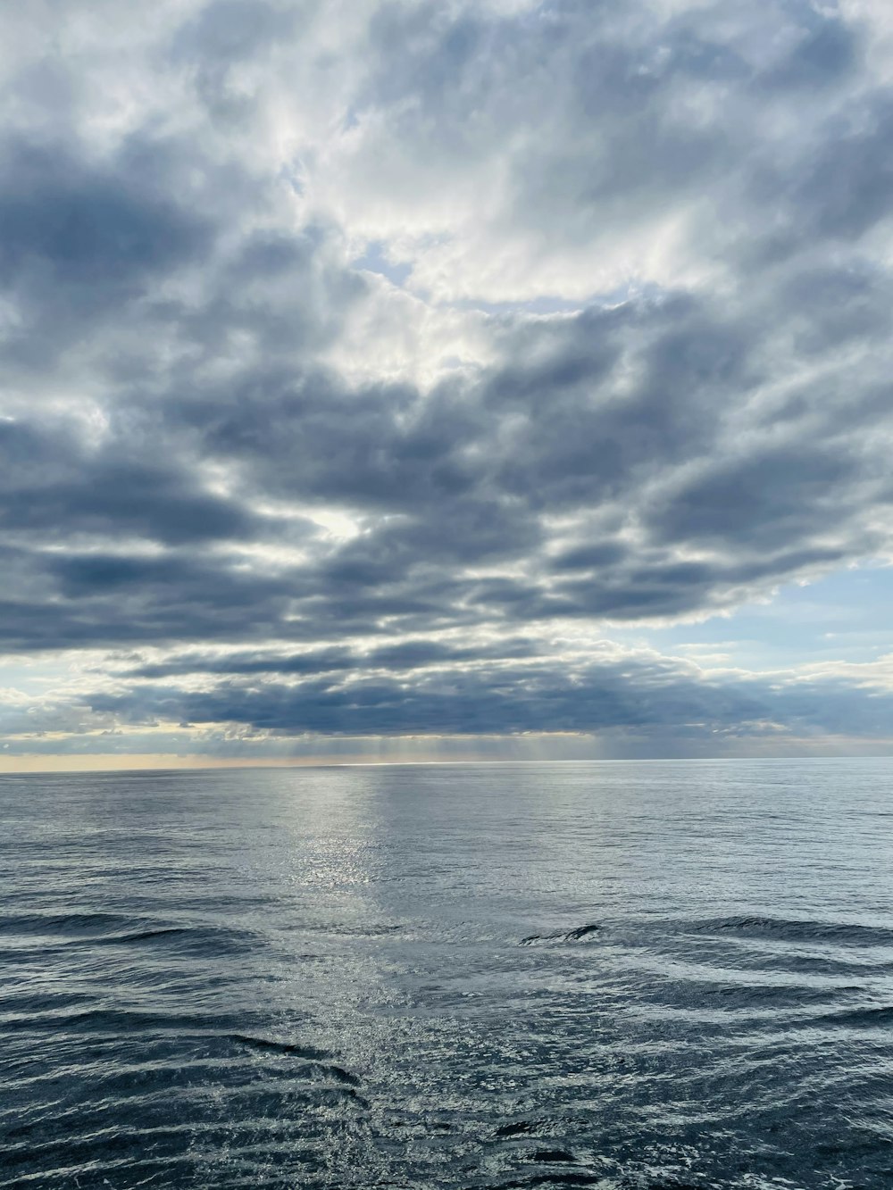 a large body of water under a cloudy sky