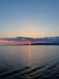the sun is setting over the ocean on a clear day