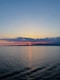 the sun is setting over the ocean on a clear day