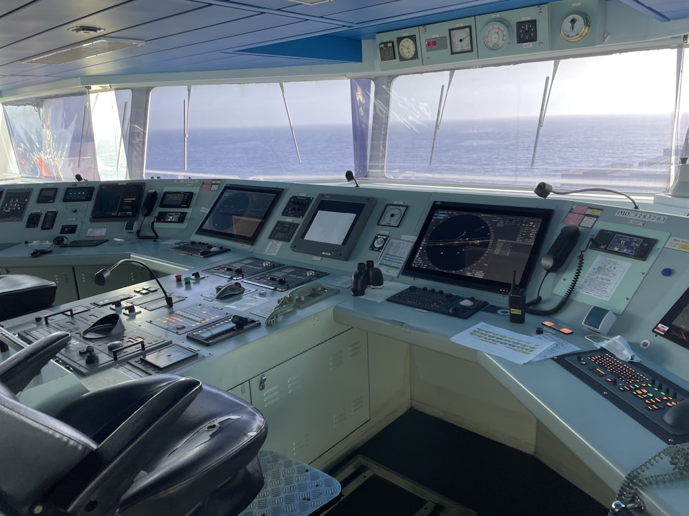 the control room of a ship with multiple monitors