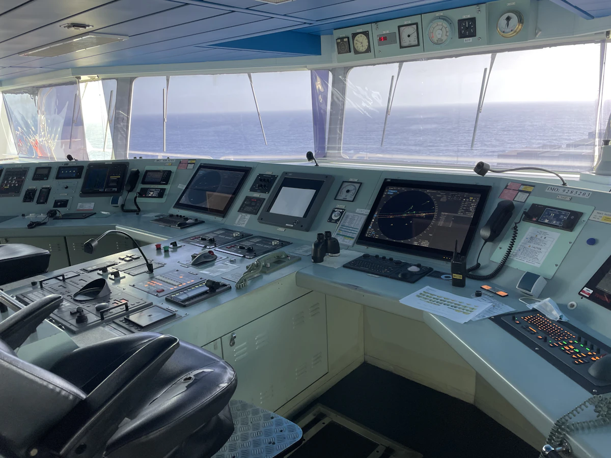 The control room of a ship filled with monitors and instrumentation, mirroring how Kubernetes—whose name means helmsman—orchestrates containers across a fleet of machines