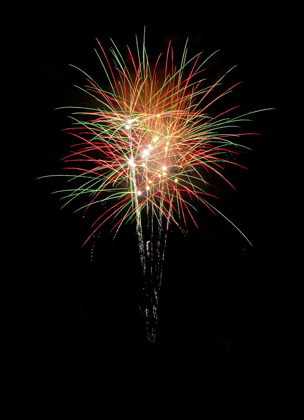 a colorful fireworks is lit up in the night sky