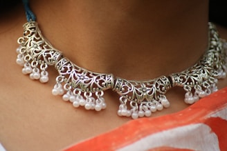 a close up of a woman wearing a necklace