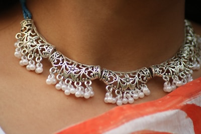 a close up of a woman wearing a necklace