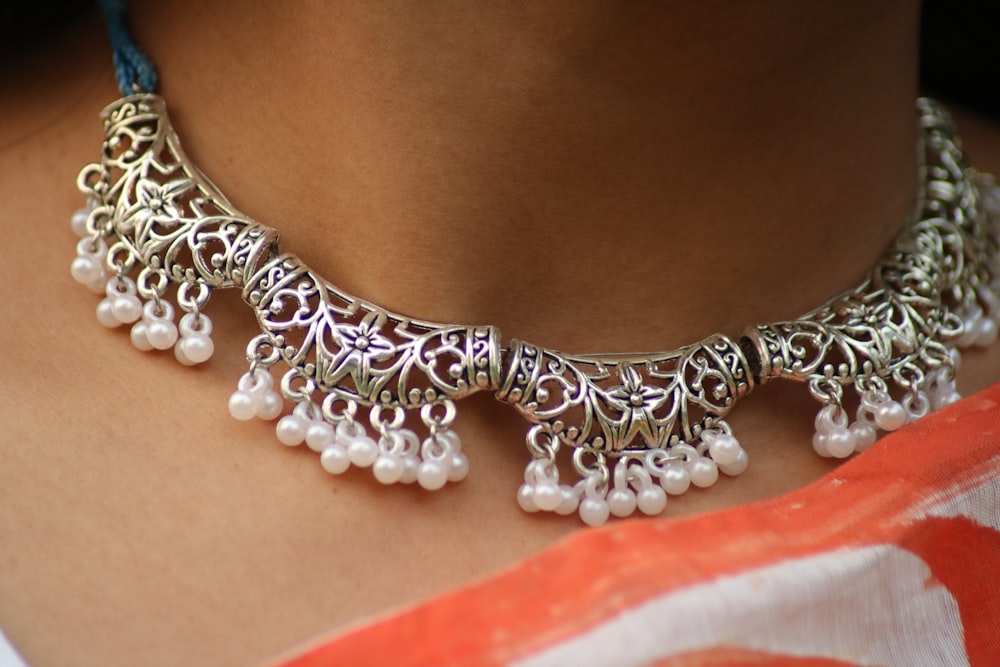 a close up of a woman wearing a necklace