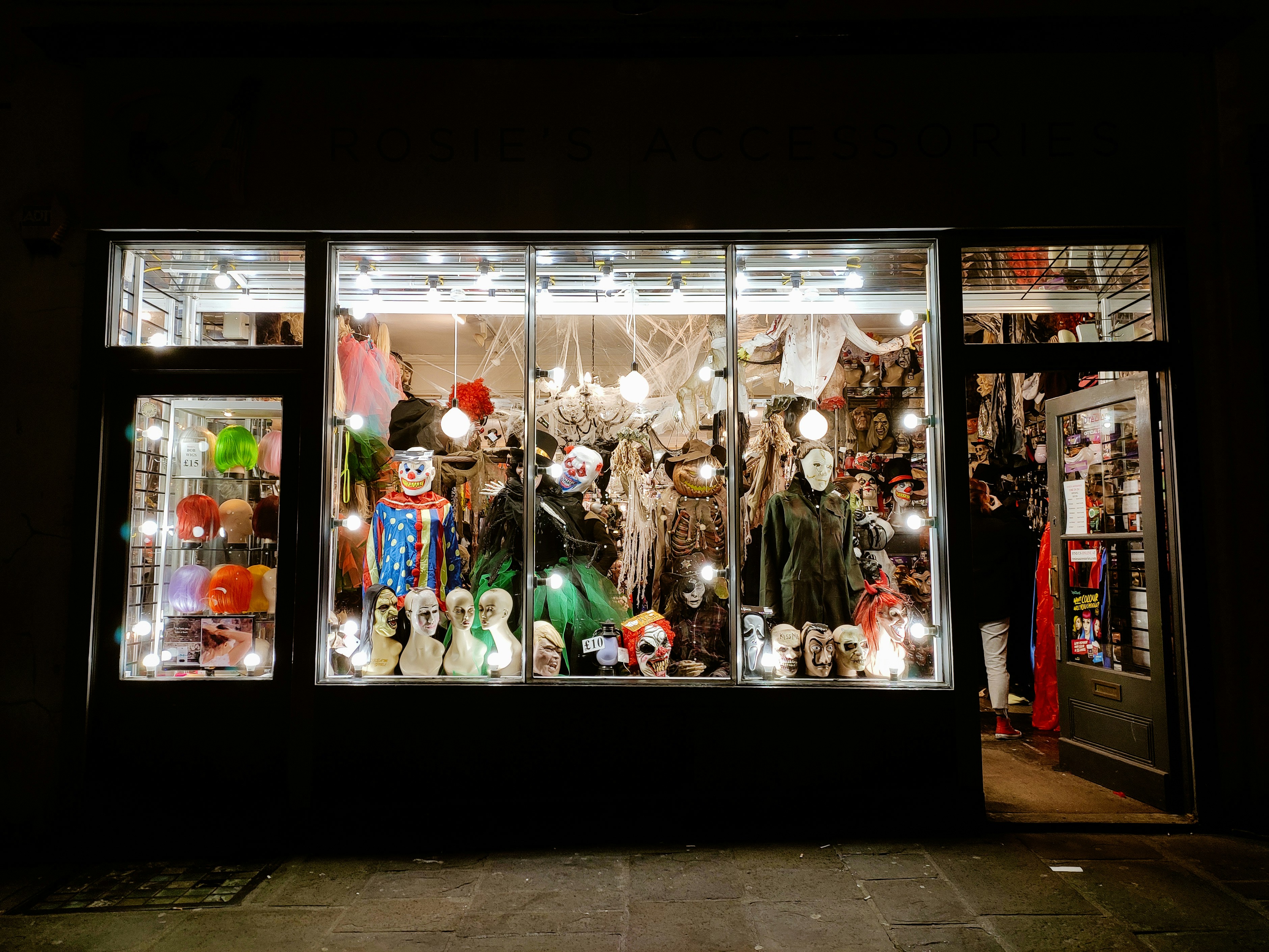 a store front with a lot of mannequins in the window