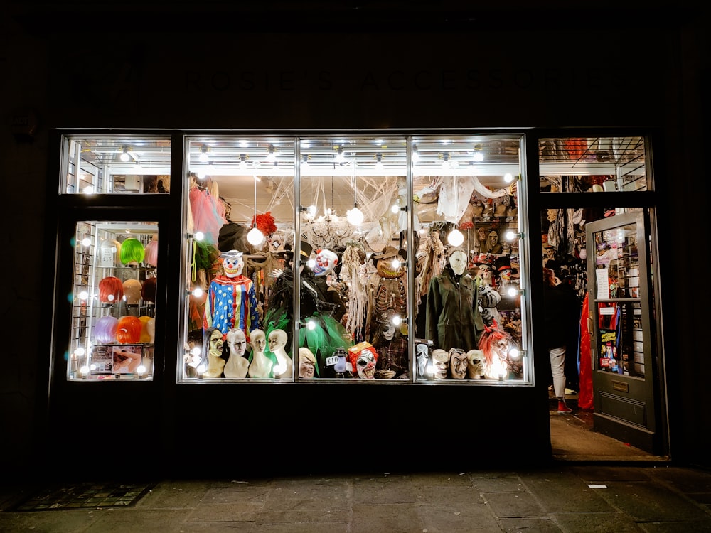 a store front with a lot of mannequins in the window