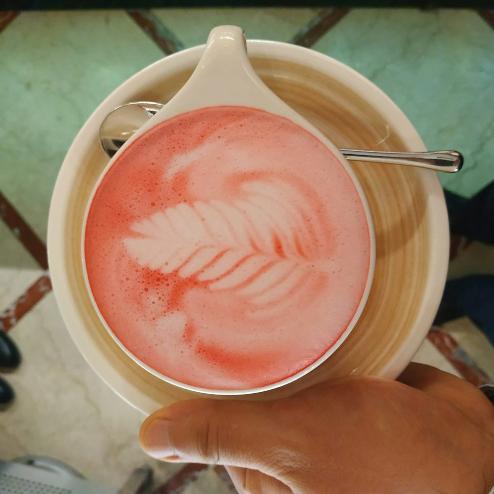 a person holding a cup with a drink in it