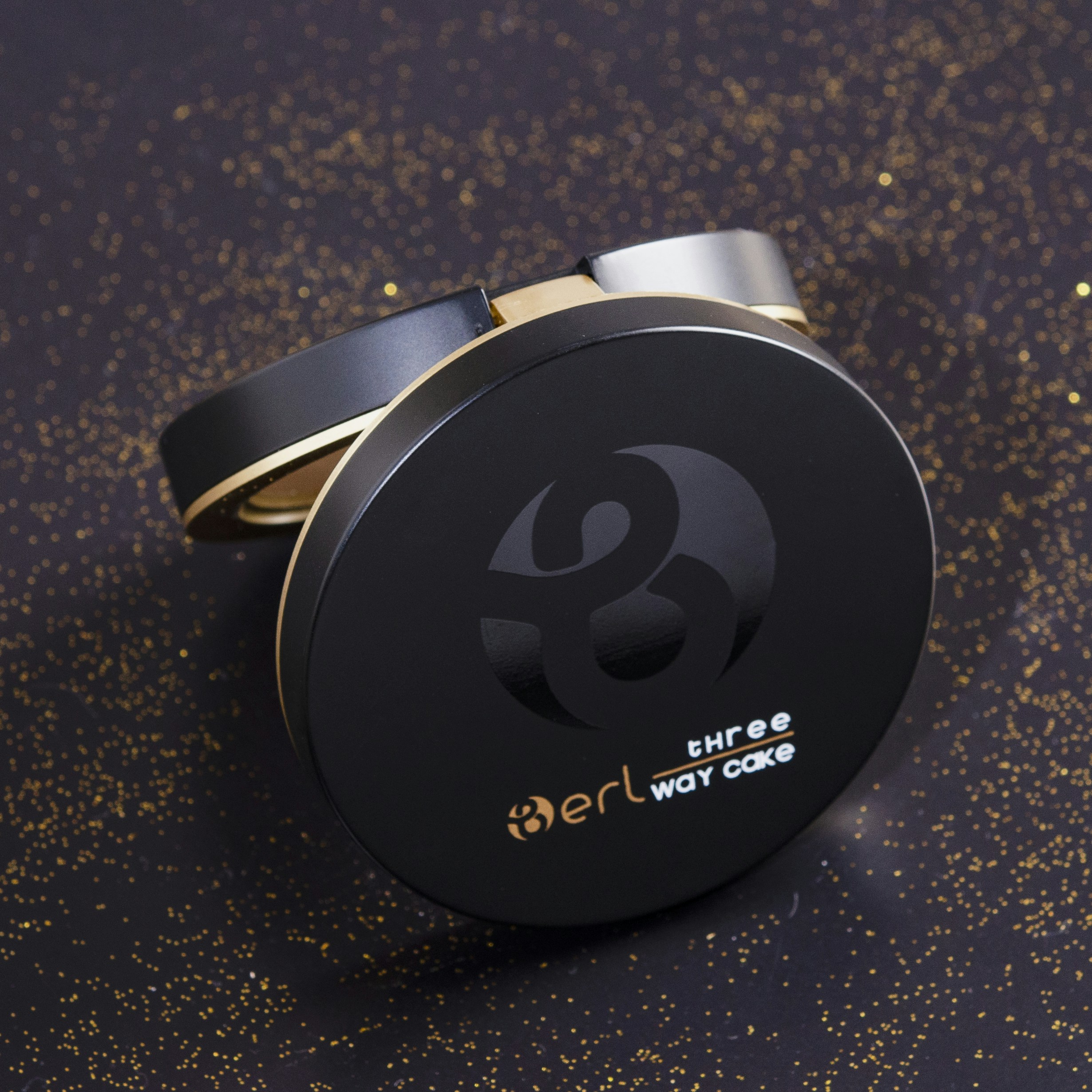 a couple of black and gold rings sitting on top of a table