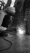 a man grinding metal with a grinder