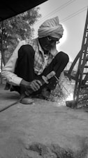 a man sitting on the ground working on something