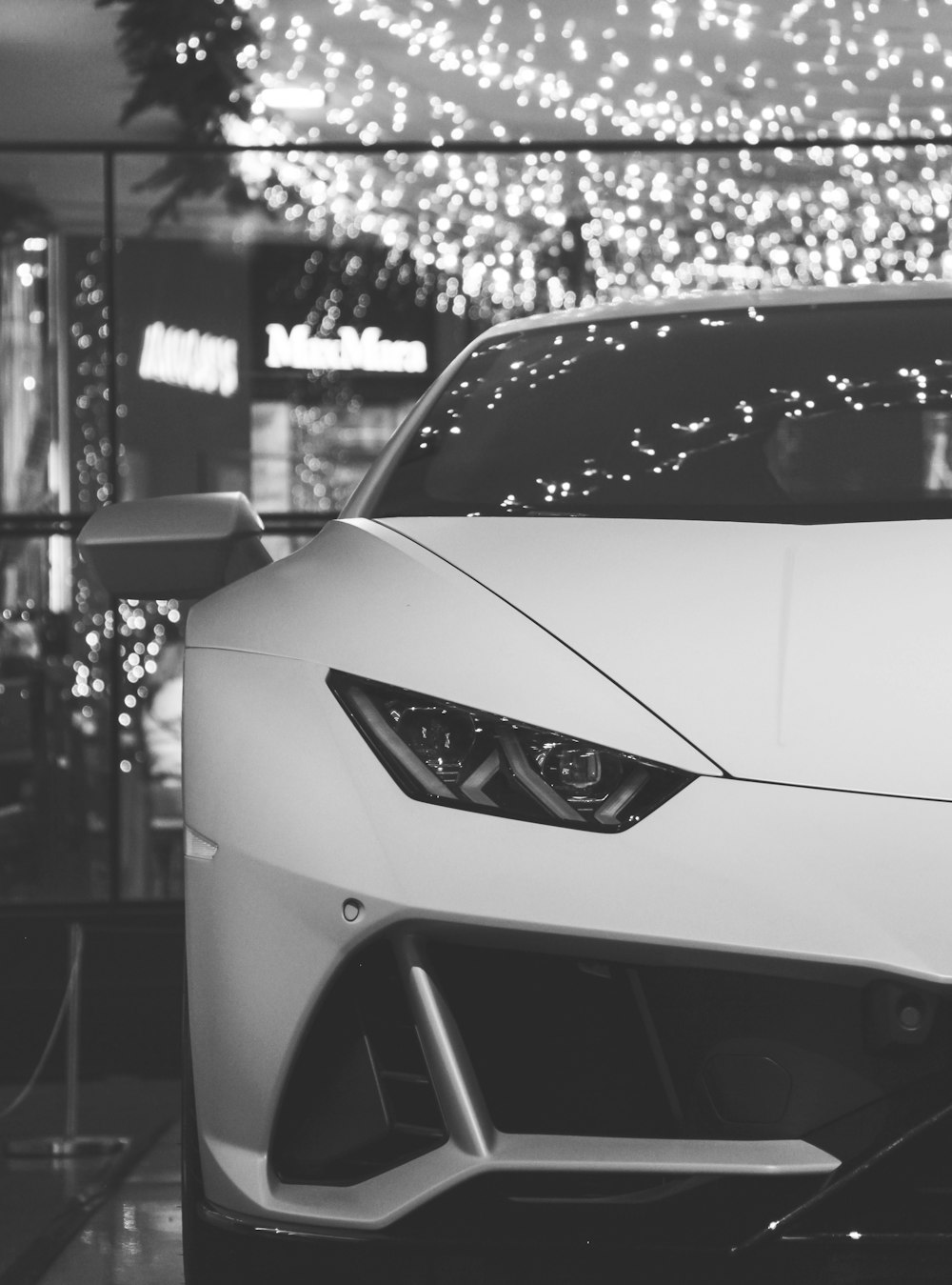 a white sports car parked in front of a building