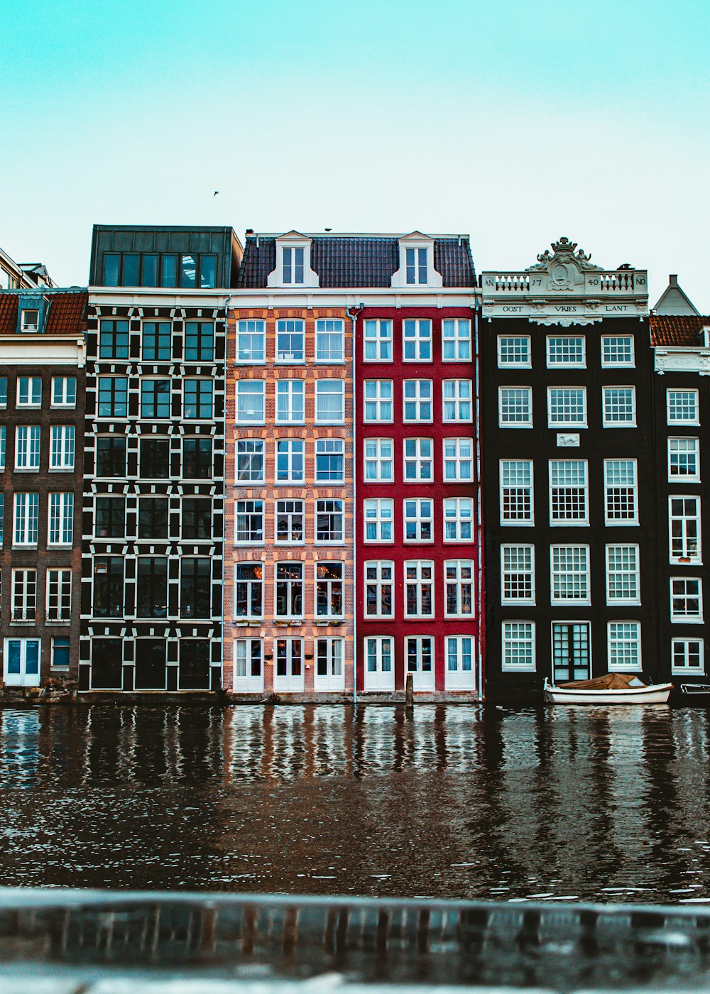 a row of buildings sitting on top of a flooded street