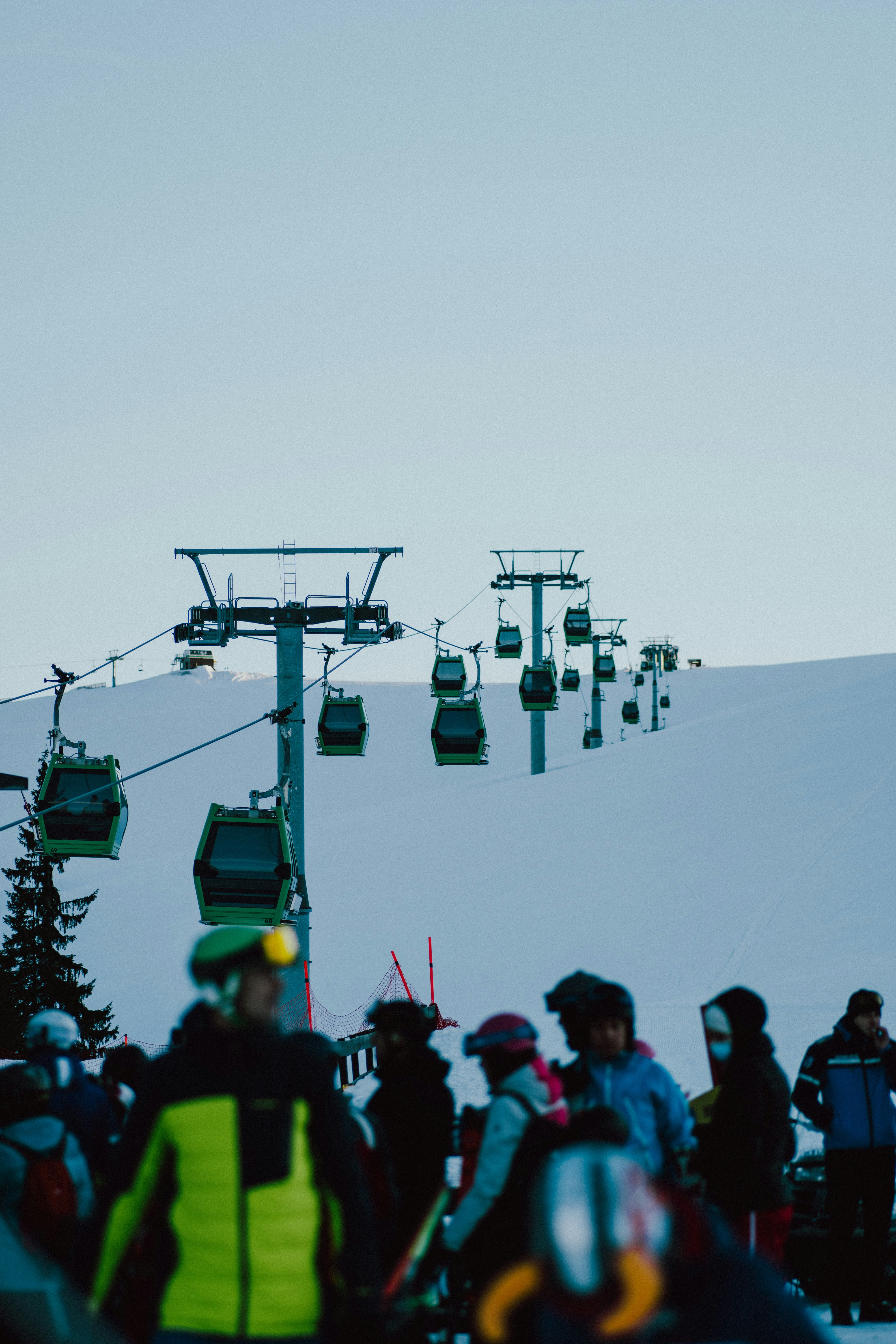 A group of people riding skis down a snow covered slope photo – Free ...