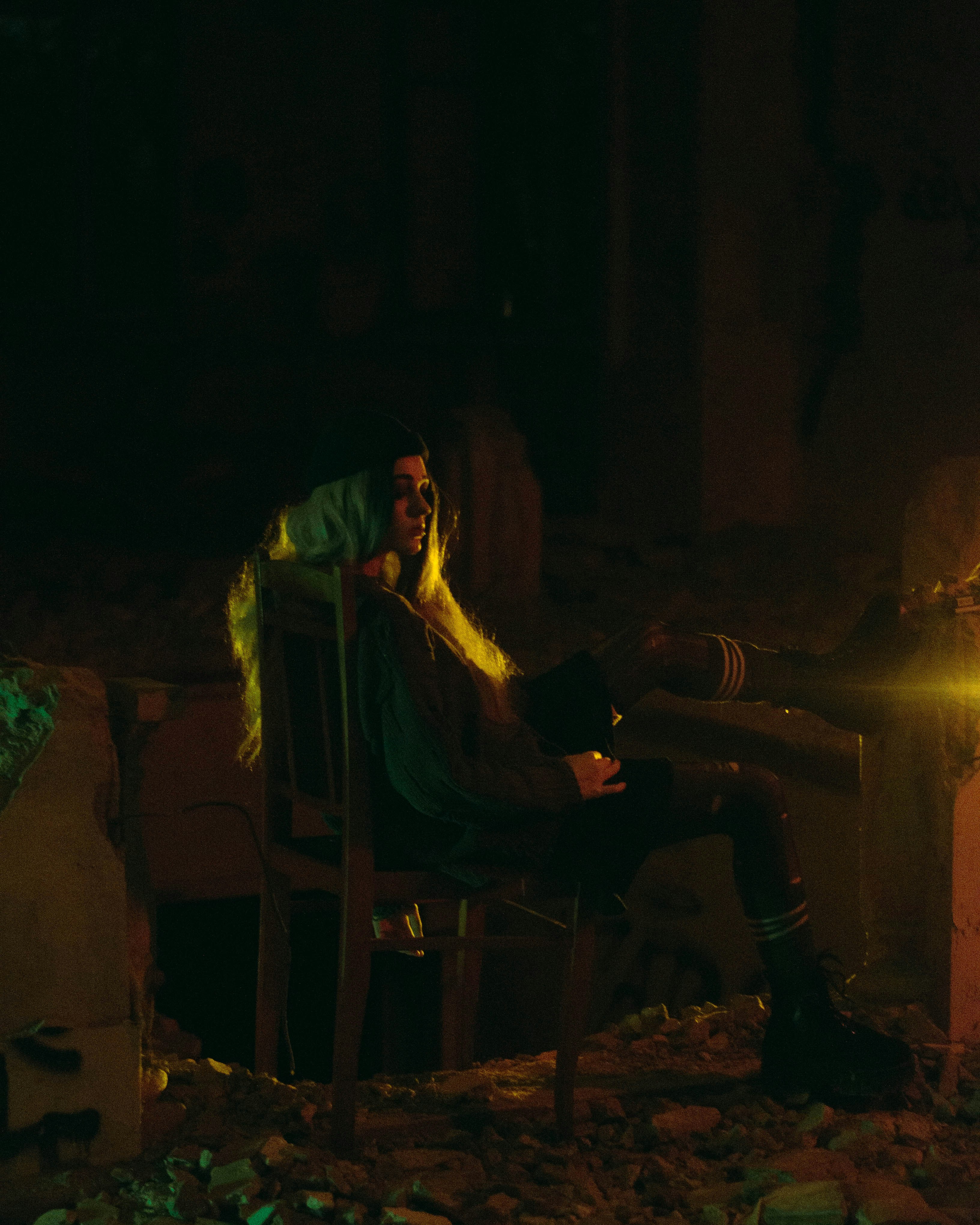 a man sitting in a chair next to a fire