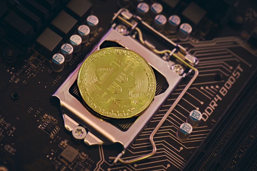 a bit coin sitting on top of a motherboard