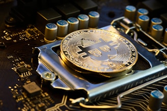 a bit coin sitting on top of a motherboard