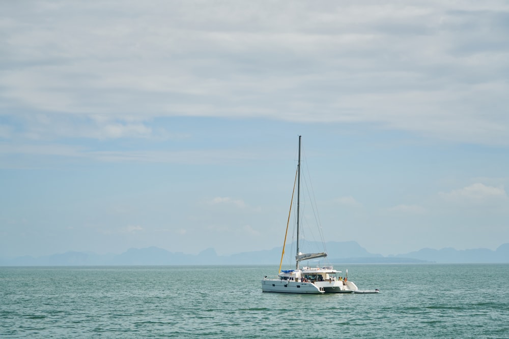 a sailboat in the middle of the ocean