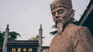 a statue of a man with a beard in front of a building